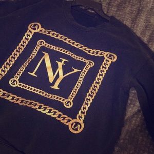 Gold emblem comfy black pull over sweater.